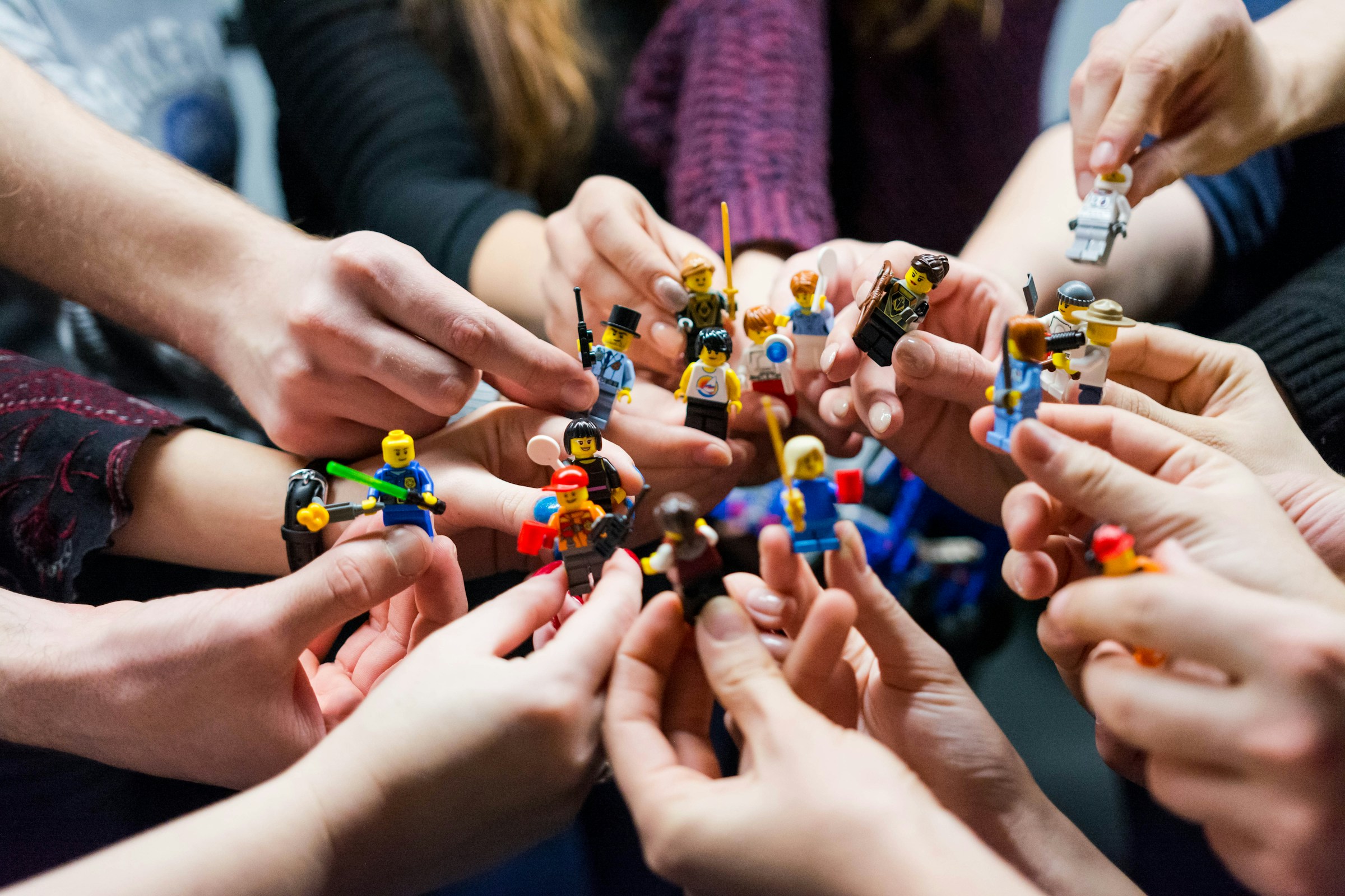 Lego characters held in a group of hands by Vlad Hilitanu from Unsplash